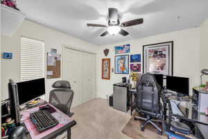 Office featuring ceiling fan and light colored carpet