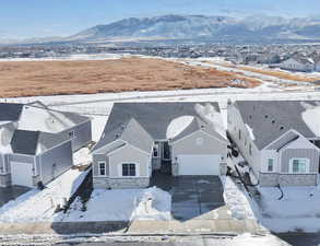 Snowy aerial view featuring a mountain view