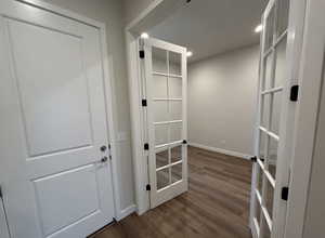 Corridor with dark hardwood / wood-style floors