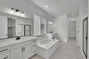 Bathroom featuring vanity, tile patterned floors, and independent shower and bath