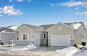 View of front of home with a garage and central AC unit