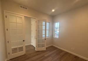 Interior space with dark wood-type flooring and french doors