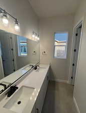 Bathroom featuring tile patterned flooring and vanity