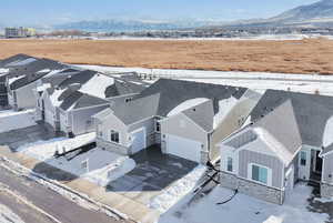 Snowy aerial view featuring a mountain view