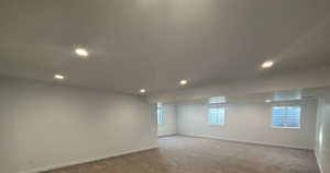 Unfurnished room featuring light carpet