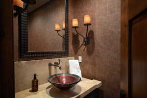 Bathroom featuring tasteful backsplash and sink