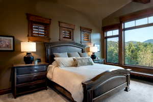 Carpeted bedroom with lofted ceiling and a mountain view