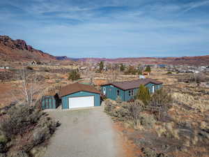 View of front of home with a shed, a mountain view, and a garage