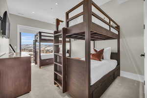 Bedroom featuring light carpet