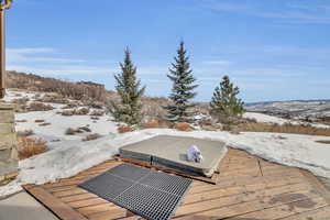 Snow covered deck with a mountain view