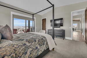 Bedroom with lofted ceiling and light carpet