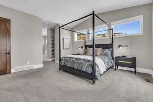 Carpeted bedroom with lofted ceiling