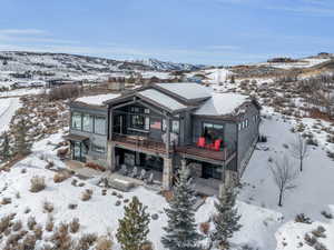 View of front of house with a deck with mountain view