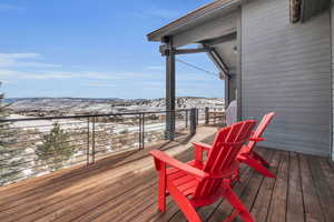 Snow covered deck featuring a mountain view