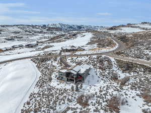 Snowy aerial view featuring a mountain view