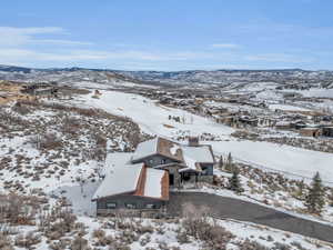 Snowy aerial view featuring a mountain view