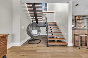 Stairway with bar and wood-type flooring