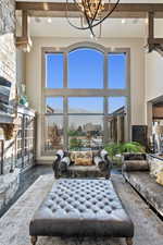 Living room featuring a mountain view, a wealth of natural light, wood-type flooring, and a high ceiling