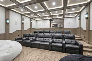 Cinema with coffered ceiling, ornamental molding, and beam ceiling