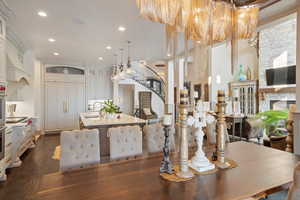 Dining space featuring dark wood-type flooring, a fireplace, and sink