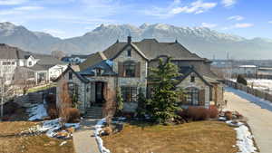 French provincial home featuring a mountain view and a front yard