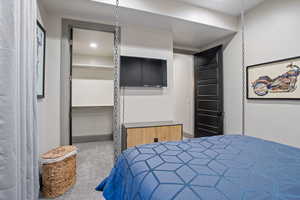 Carpeted bedroom featuring a closet