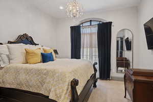 Carpeted bedroom with a chandelier