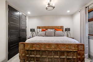 Bedroom with a chandelier and carpet