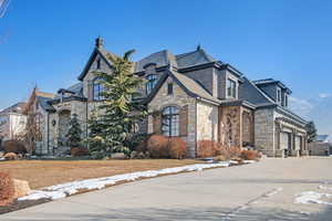 View of front of home with a yard and a garage