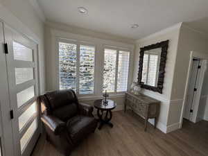 Sitting room featuring hardwood / wood-style flooring, ornamental molding, and a textured ceiling