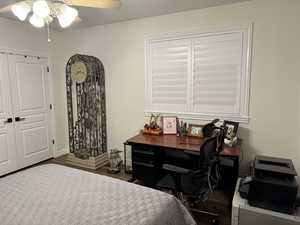 Bedroom featuring ceiling fan and dark hardwood / wood-style flooring