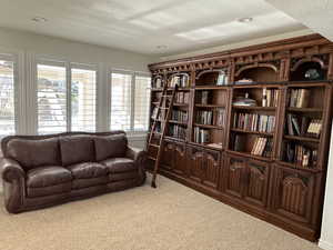 Sitting room with a textured ceiling and carpet