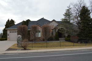 View of front of property with a garage and a front lawn