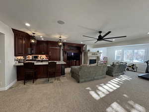 Living room with light carpet, a textured ceiling, and ceiling fan