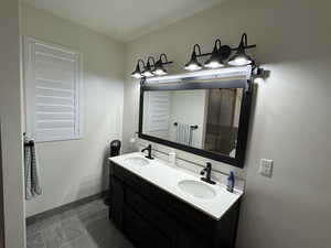 Bathroom featuring tile patterned floors and vanity