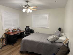 Bedroom featuring hardwood / wood-style floors and ceiling fan