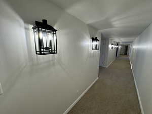 Corridor with light colored carpet