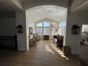 Interior space featuring hardwood / wood-style flooring and high vaulted ceiling