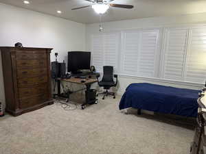 Bedroom featuring ceiling fan and light carpet