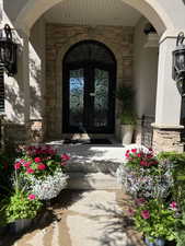 View of exterior entry with covered porch