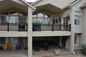 Rear view of property featuring a patio area and a balcony