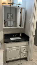 Bathroom featuring tile patterned flooring and vanity