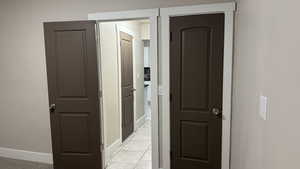 Corridor featuring light tile patterned floors