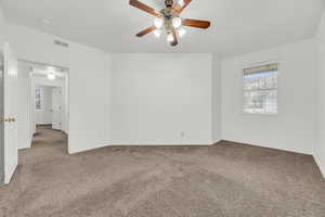 Unfurnished room with ceiling fan and carpet flooring