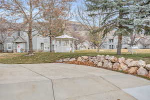 View of community featuring a mountain view, a gazebo, and a lawn