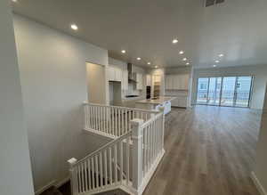 Hall featuring light wood-type flooring