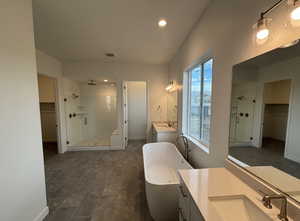 Bathroom featuring vanity and plus walk in shower