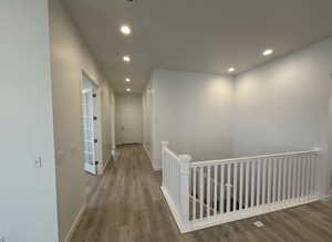 Corridor featuring wood-type flooring