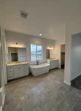 Bathroom featuring vanity and a bath