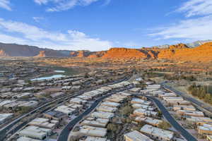 Drone / aerial view featuring a water and mountain view